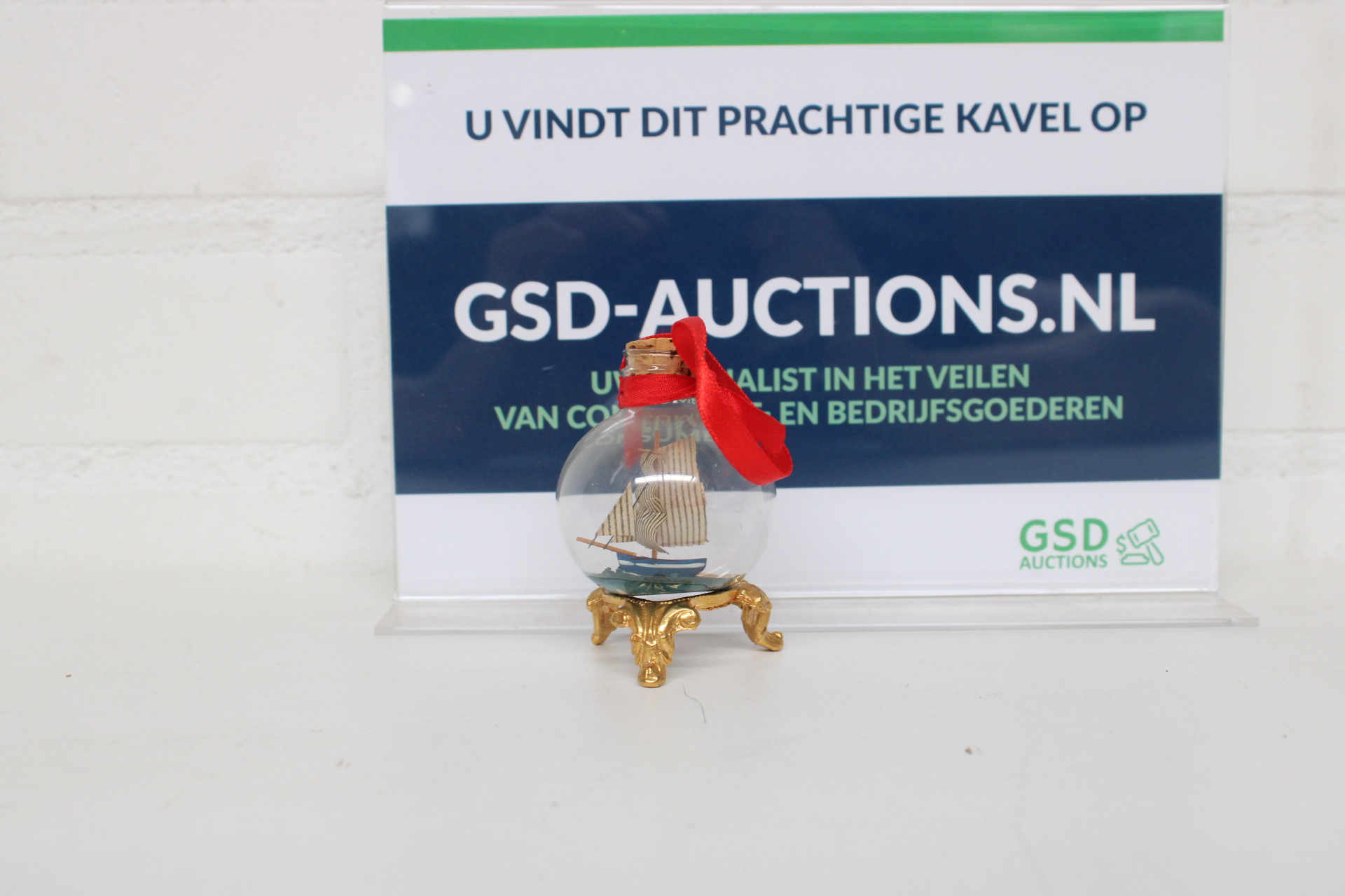 Miniatuur boot in glazen bol met gouden standaard – kavel bij GSD Auctions, Zoeterwoude