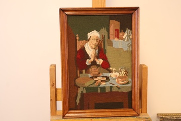 Afbeelding van Geborduurd schilderij met vrouw aan tafel