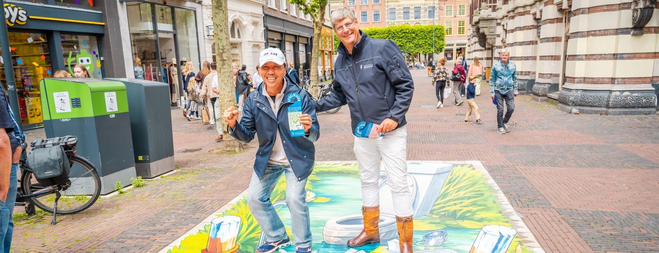Hoogheemraad Harry Kortman informeert voorbijganger over de 'Spoel wijzer'-campagne
